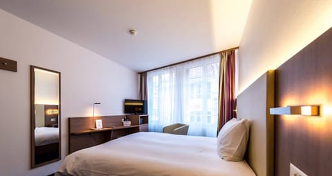 Standard Double Room | Minibar, in-room safe, desk, blackout drapes