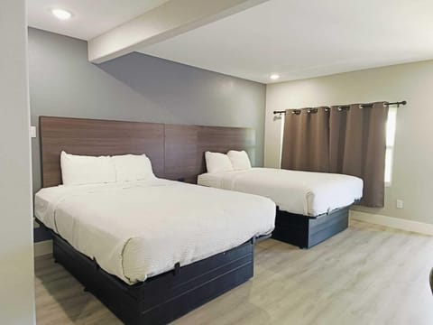 Deluxe Room, Multiple Beds, Non Smoking | Iron/ironing board, WiFi (free), bed sheets