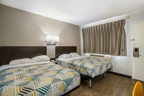 Desk, laptop workspace, bed sheets