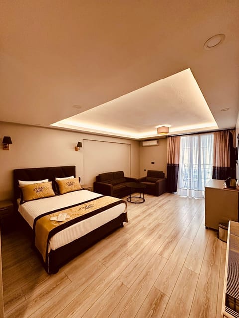 Deluxe Room with Balcony | In-room safe, laptop workspace, blackout drapes, soundproofing
