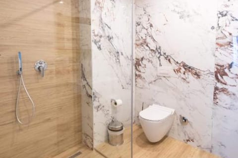 Triple Room With Side Sea View | Bathroom | Shower, hair dryer, slippers, towels