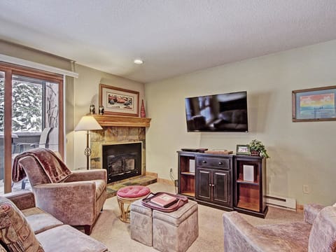A cozy living room with a fireplace and TV.