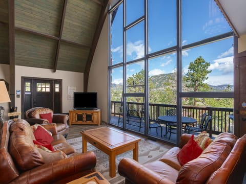 Sky View in the Rockies -- 20-NCD0283 - a SkyRun RMNP Property - Sky View in the Rockies - Living Room features floor to ceiling  windows overlooking the deck with mountain views