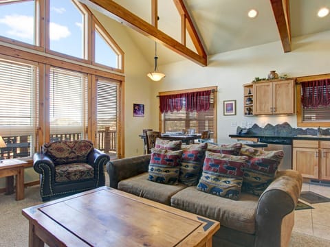 Mount Enentah 37 - a SkyRun RMNP Property - Mount Enentah 37 - Open concept living/dining room area with floor-to-ceiling windows boasting mountain views that can be enjoyed from the queen sleeper sofa or oversize chair.