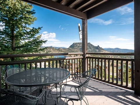 Powell Peak 104 - a SkyRun RMNP Property - Powell Peak 104 - Patio seating for four guests on the condo's deck, surrounded by beautiful mountain views.