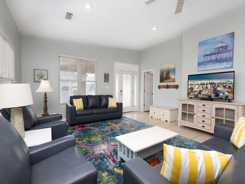 The spacious living area features new furniture to help you relax and unwind after a long day on the beach. Watch your favorite shows on the large television or enjoy some quality time together in conversation.