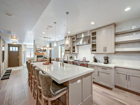 Your gourmet kitchen awaits with sleek white countertops, modern appliances, and a spacious island perfect for cooking and gathering with loved ones.