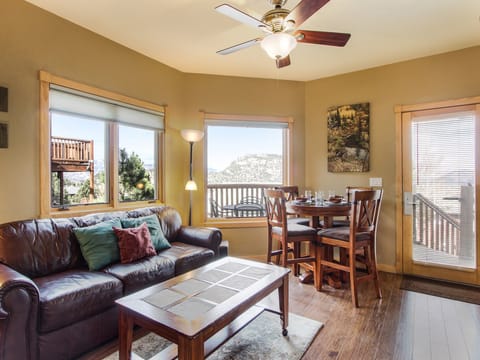 Deer Mountain 28B - a SkyRun RMNP Property - Deer Mountain 28B - Enjoy the natural and gorgeous mountain views from the combo living/dining area, equipped with a comfortable queen sleeper sofa and bar-height table with seating for four.