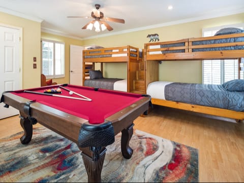 Playroom with 4 twin beds. Pool table, skee all, darts, karaoke and board games. Smart TV
