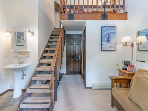 Step into your cozy mountain retreat with soaring ceilings, a stylish loft above, and charming ski-themed décor that sets the perfect alpine mood for your getaway.