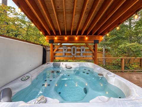 Private Year Round Covered Hot Tub adorned with the soft glow of Edison Bulbs