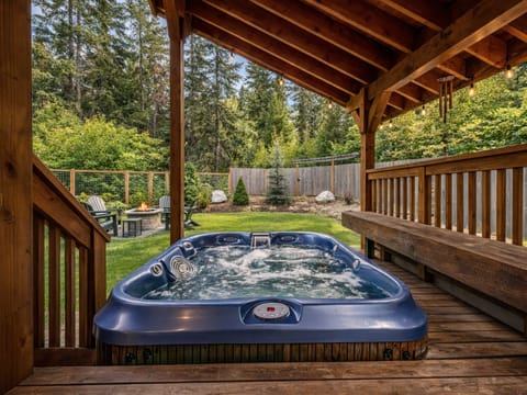 Soak in your private hot tub under the covered deck, surrounded by lush forest views and complete tranquility.