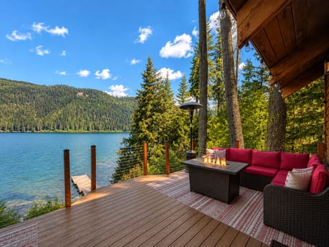 Outdoor deck overlooking the lake with propane grill and seasonal outdoor furniture with propane fire pit