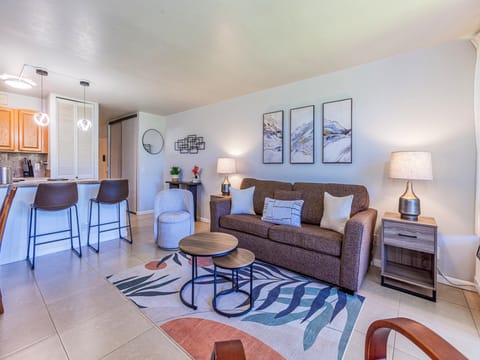 Step into your inviting living space, where a plush sofa and comfortable seating create the perfect spot to unwind after a day of adventure. Modern touches and thoughtful decor make this your home away from home.