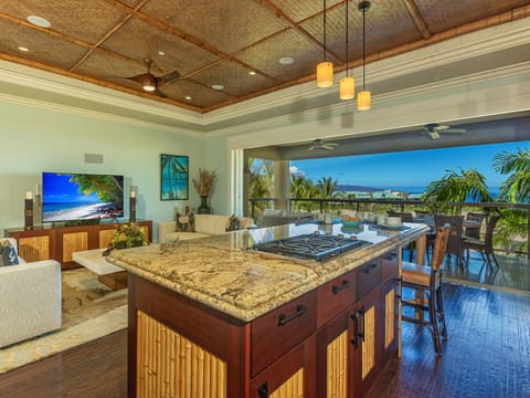 Step into your island oasis where warm woods meet tropical breezes. Cook in your chef's kitchen while gazing at swaying palms and sparkling ocean views beyond the open-air lanai—your perfect Hawaiian escape awaits.