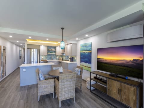 Step into your light-filled retreat where the open layout seamlessly blends kitchen, dining, and living spaces. Relax at the coastal-inspired dining table or unwind in comfort with modern amenities and breezy, beach-inspired décor welcoming you home.