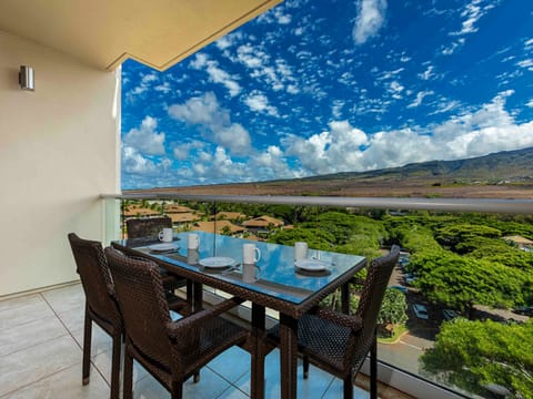 Your private lanai beckons with panoramic mountain and coastal vistas stretching to the horizon.
