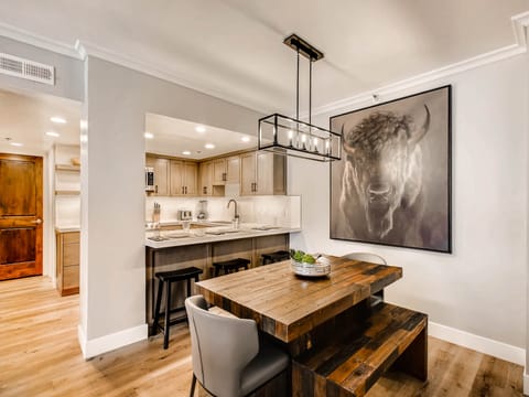 Kitchen opens to the dining room, feature bison wall art