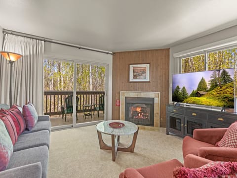 The living room offers comfortable furniture and a cozy fireplace and flat screen TV.