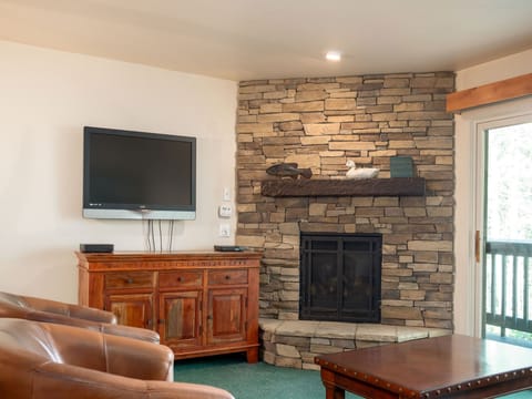 Living room includes a wall mounted flat screen and gas fireplace