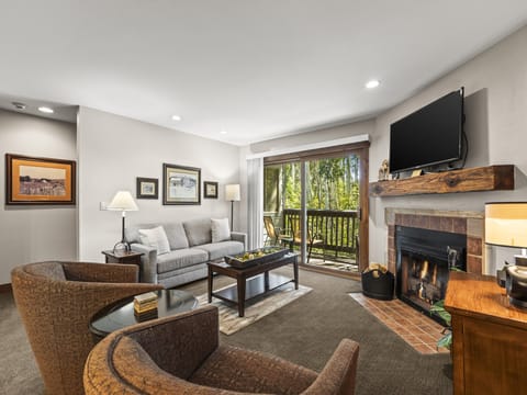 Snow Flower 142 has a cozy gas burning fireplace and TV in the living room.
