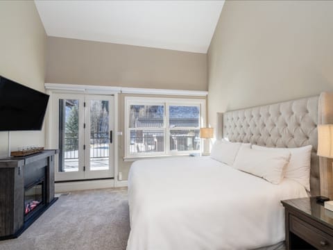 The primary suite is located on the second level of the condo and features an ensuite bathroom, King bed, electric fireplace and access to the outdoor shared deck area.