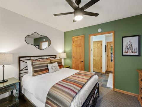 Step into the unit through the bright and fresh primary bedroom, featuring a comfortable queen bed.