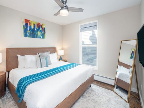Master bedroom with a king sized bed.