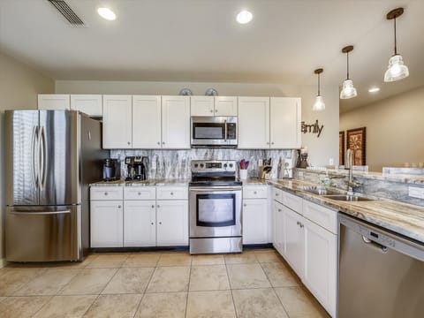Kitchen is fully stocked and has stainless steel appliances