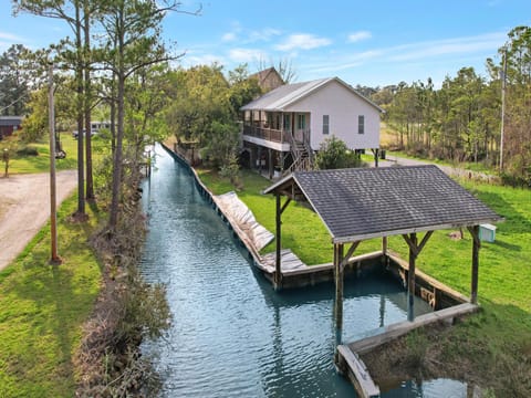 White Lane property is located in Gulf Shores on beautiful Plash Island, and features canal frontage, perfect for fishing and boating.