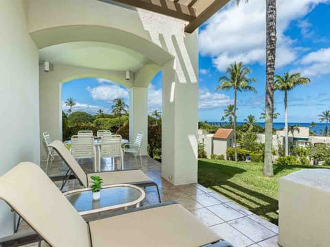 Relax on your private lanai with ocean breezes, tropical palms, and sweeping sea views stretching to the horizon—your perfect island escape.