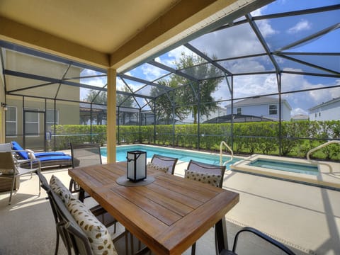 The spacious lanai and pool area is a stunning retreat that seamlessly blends indoor and outdoor living
