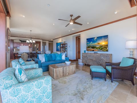 Sink into plush coastal-inspired seating and let the ocean breeze from your ceiling fan wash over you in this spacious, light-filled retreat.