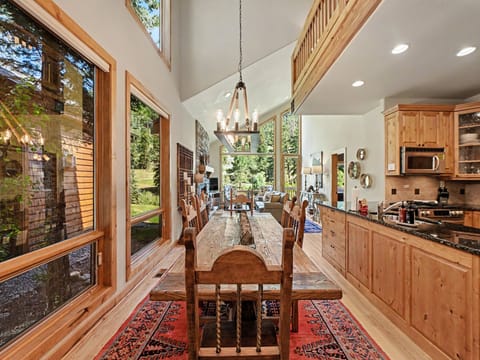 Sunlight streams through floor-to-ceiling windows, illuminating your rustic dining space with seating for 6.