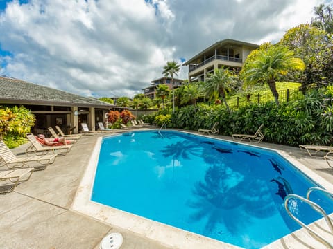A sparkling pool surrounded by lush tropical landscaping awaits you at this inviting property, framed by mountain views and kissed by Hawaiian sunshine.