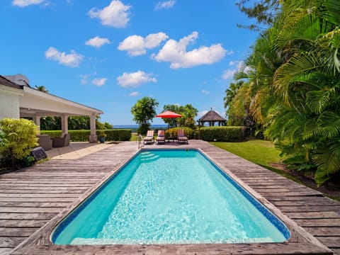 The stunning pool deck complete with loungers and umbrellas