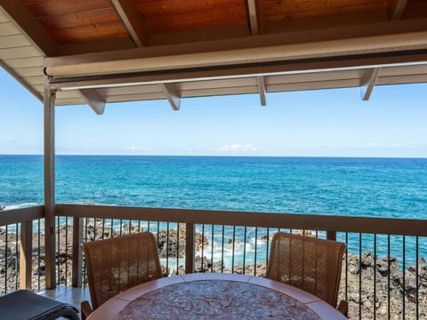 Imagine sipping your morning coffee at this covered terrace with turquoise waves just beyond your railing. The sea breeze and endless blue horizon make every moment here feel like pure escape.