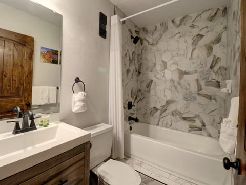 Nicely updated bathroom with shower/tub combo.