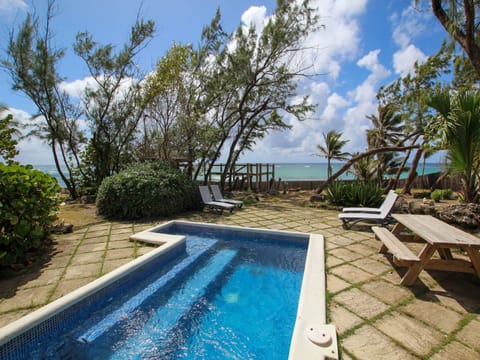 View from the covered verandah of the pool and gardens