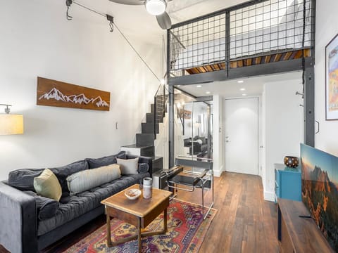 Spacious studio with Queen bed, closet for storage, high ceilings, and modern style.