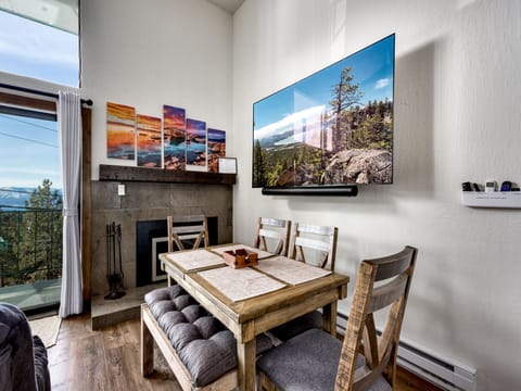 Dining area with a cozy fireplace, ideal for shared meals and game nights.
