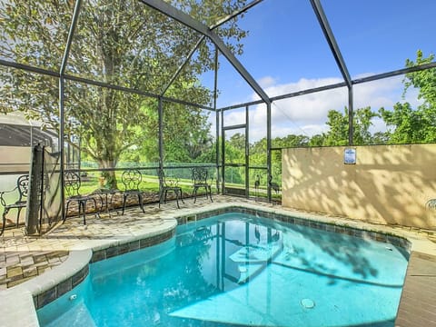 Private screened pool surrounded by lush greenery for a serene escape.