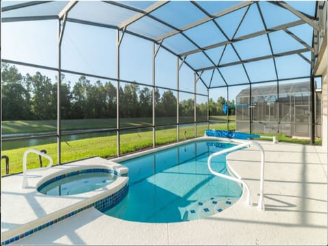 Relax in a private screened-in pool with stunning views of the green landscape.