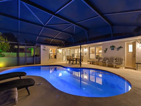Relax by the illuminated pool under a screened lanai for ultimate privacy and comfort.