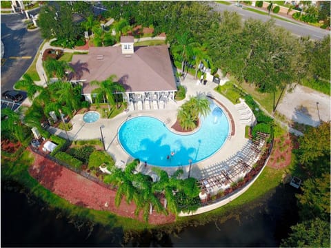Stunning aerial view of the resort-style pool surrounded by lush greenery