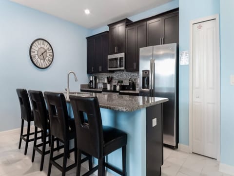Modern kitchen with sleek appliances and a spacious breakfast bar.