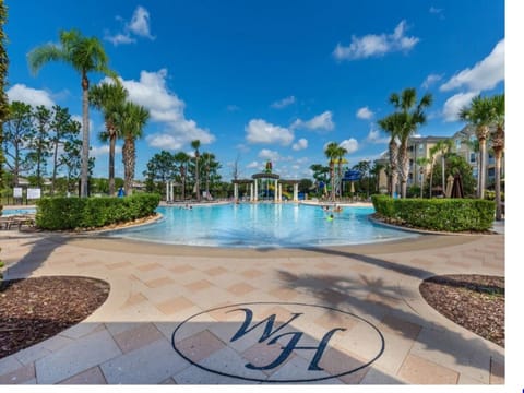 Resort-style pool surrounded by lush palm trees – perfect for relaxation or a refreshing swim.