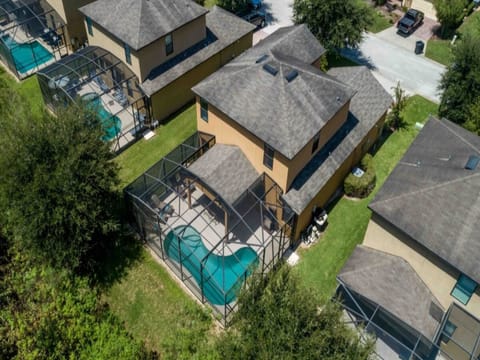 Stunning aerial view showcasing the home and its private pool oasis.