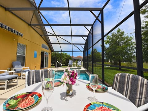 Outdoor dining by the pool with a scenic view for ultimate relaxation.