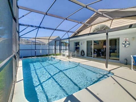 Screened private pool with plenty of sunlight and lounge space.